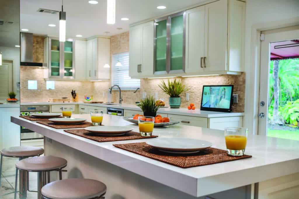 Bright modern kitchen with island, white cabinetry, and breakfast bar for family dining and entertaining.